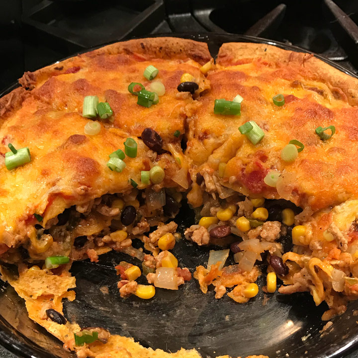 Mexican Casserole Recipe - Small dinner pie made with salsa, tortillas, refried beans, cheese, and onions. #mexican #cassserole #recipes #mexicanrecipes #casserolerecipes #casserolerecipe #mexicancasserole #mexicanfood #mexicancasserolerecipe